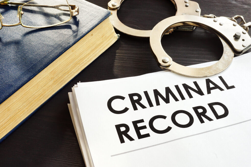 Criminal record and handcuffs on a table